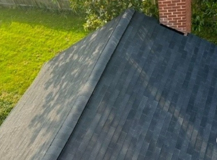 dark grey roofing with a bricked chimney