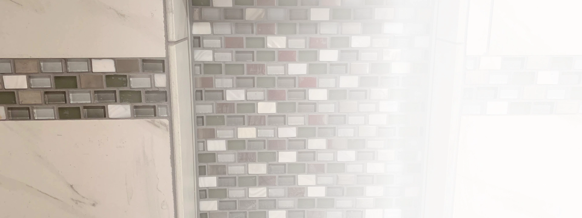 small tiles on a beige wall